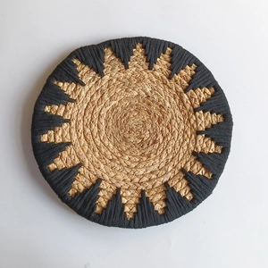 Bohemian circular grass woven wall decor with black sun pattern and natural fiber texture