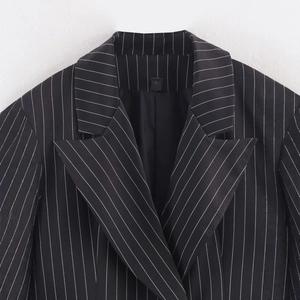 Classic black striped blazer with peak lapel detailing and fine tailoring texture