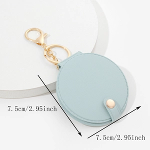 Macro view of light blue round PU leather keychain mirror with a 7.5cm diameter size detail