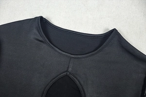 Detail of round neckline with teardrop cutout on black slim fit long sleeve dress
