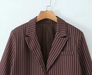 Close-up of brown striped blazer with notch lapels and detailed white vertical pinstripes