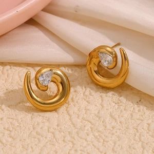 Golden spiral snake earrings with teardrop zirconia set on elegant silk fabric