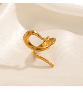 Macro shot of minimalist gold plated wavy ring with a brushed matte finish on silk