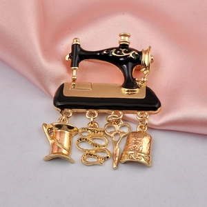Detailed macro of vintage sewing machine brooch with scissors and thimble charms
