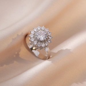 Minimalist spinning silver ring with sunflower petal design and sparkling crystals