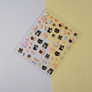 Detailed 45-degree macro view of 3D embossed black bear and biscuit nail art stickers