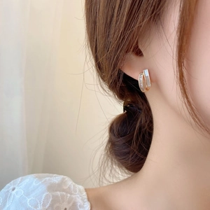 Elegant gold double-layer huggie earrings with mother of pearl and sparkling zircon stones