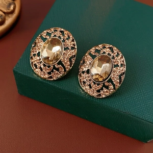 Vintage gold oval earrings with amber crystal and intricate hollow metal floral details
