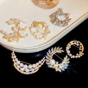 Macro view of shell flower brooch set with 18k gold plating and sparkling zircon details