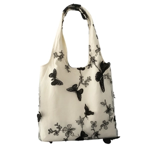 Borsa tote in tela bianca con ricami di farfalle nere e sovrapposizione in pizzo