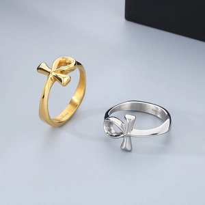 Macro view of gold and silver stainless steel Ankh cross rings showing size engraving