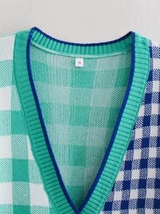 Close-up of mint green and navy checkered knit sweater neckline with size S tag
