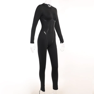 Side view of black long sleeve jumpsuit featuring zip front and sleek stitching lines