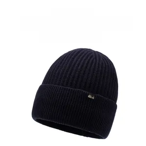 Detailed knit texture and brown logo patch on navy blue winter beanie cuff