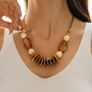Detail shot of vintage bohemian necklace with layered acrylic pendants and leather cord