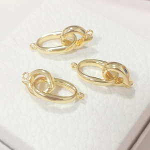 Detailed macro view of three golden S925 sterling silver DIY jewelry clasps for necklaces