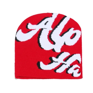 Detailed knit texture of red Ho Ho festive beanie hat with jacquard holiday lettering