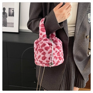 Detailed shot of pink leopard plush bag with drawstring closure and golden chain strap