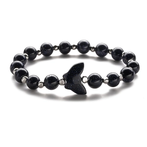Blue sandstone beaded bracelet featuring a silver fishtail charm on a white background