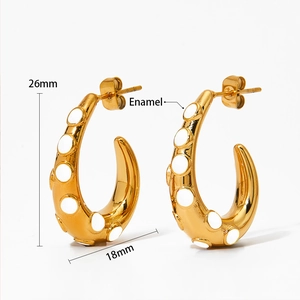 Detailed view of C-shape gold earrings with white enamel dots and 26mm height size
