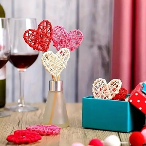 Handmade rattan heart decorations and fiber diffuser sticks in red, pink, and beige colors