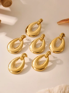 Detailed view of geometric hollow teardrop earrings in polished 18k gold-plated finish