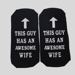 Detail showing non-slip sole lettering This Guy Has An Awesome Wife on black cotton socks