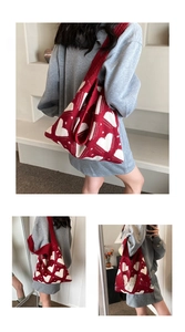 Detail of red and white heart knit tote bag showing soft texture and large shoulder strap