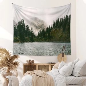 Bohemian wall tapestry with mountain and lake landscape in minimalist bedroom