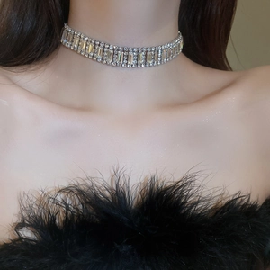 Detailed view of shimmering silver rhinestone choker necklace on female model neck