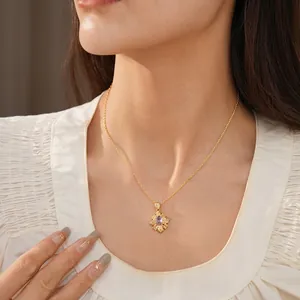 Vintage gold necklace with a purple zircon flower pendant worn on a model neck