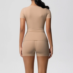Back view of a nude-colored two-piece yoga set with slim fit T-shirt and tight shorts