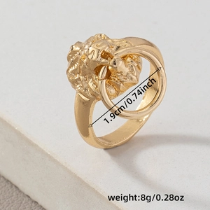 Hip hop style gold lion head ring with nose ring detail on a stone surface