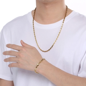 Detail of 5mm stainless steel gold link necklace and bracelet set on male model