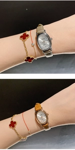 Detail of vintage ladies small oval watch with grey and brown leather straps worn by model
