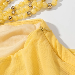 Macro detail of high-quality yellow mesh fabric texture and invisible zipper closure