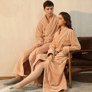 Matching plush flannel bathrobes for couples featuring large lapels and belted waist design