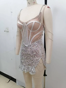 Detail of silver sequin dress showing mesh panels, rhinestone lines and bead chains