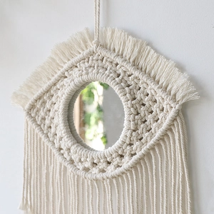 Handmade boho macrame wall mirror with cotton rope fringe and evil eye design for bedroom deco