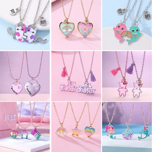 Detail of colorful BFF and sister charm necklaces with enamel finish and gold plating