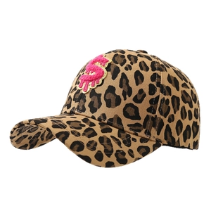 Leopard print baseball cap with pink plush dollar sign patch on a clean white background