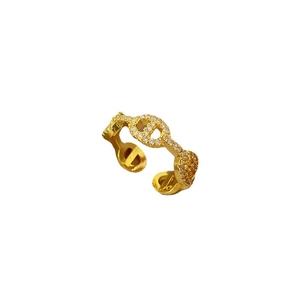 Adjustable gold plated pig nose ring with pave zircons on white background