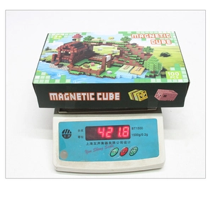 Detailed shot showing 100pcs magnetic building blocks weighed at 421.8g on a digital scale