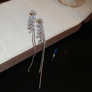 Detail of silver long tassel earrings featuring zircon wheat leaf design and snake chains