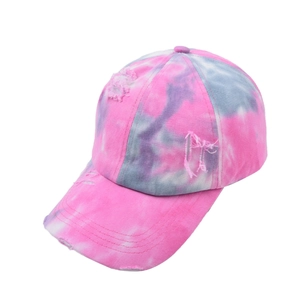 Detail of distressed tie-dye baseball cap with pink and grey-blue frayed hole effects