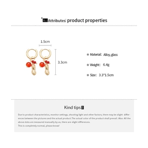 Detail view of crystal beaded peanut drop earrings with size and weight specifications