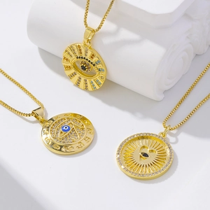 Three gold evil eye necklaces with colorful zircon stones on elegant plaster pedestals