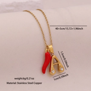 Detail showing red chili and letter A pendants on a gold chain with dimension markers