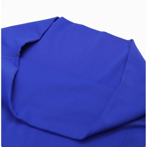 Detailed macro view of high-elastic flatlock stitching on dark blue yoga shorts