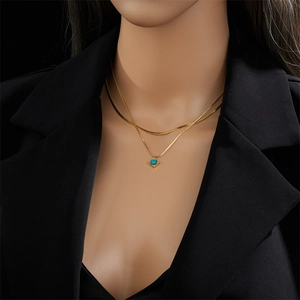 Double-layered gold titanium necklace featuring a square turquoise pendant on a snake chain